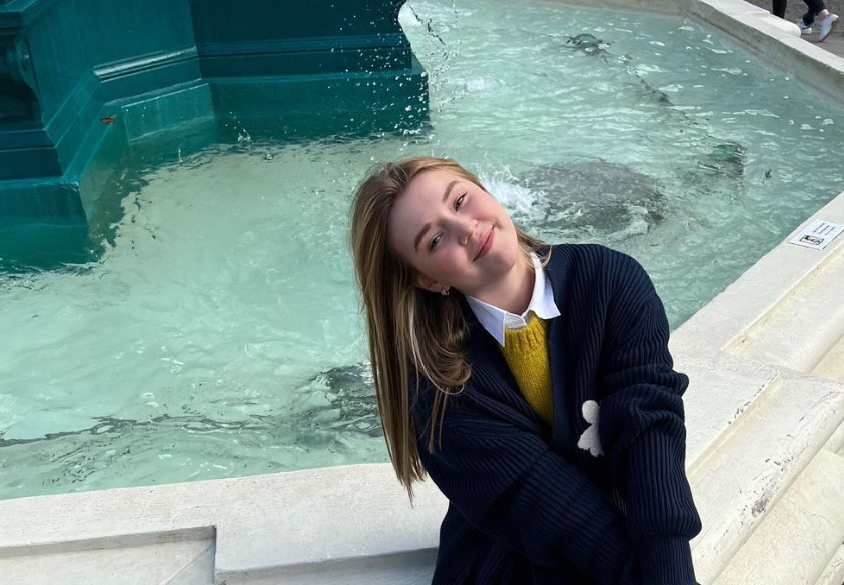 lady in front of a water fountain 